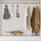 Bag-a-Vie gold metal handbag hangers holding luxury purses in a neatly organized closet