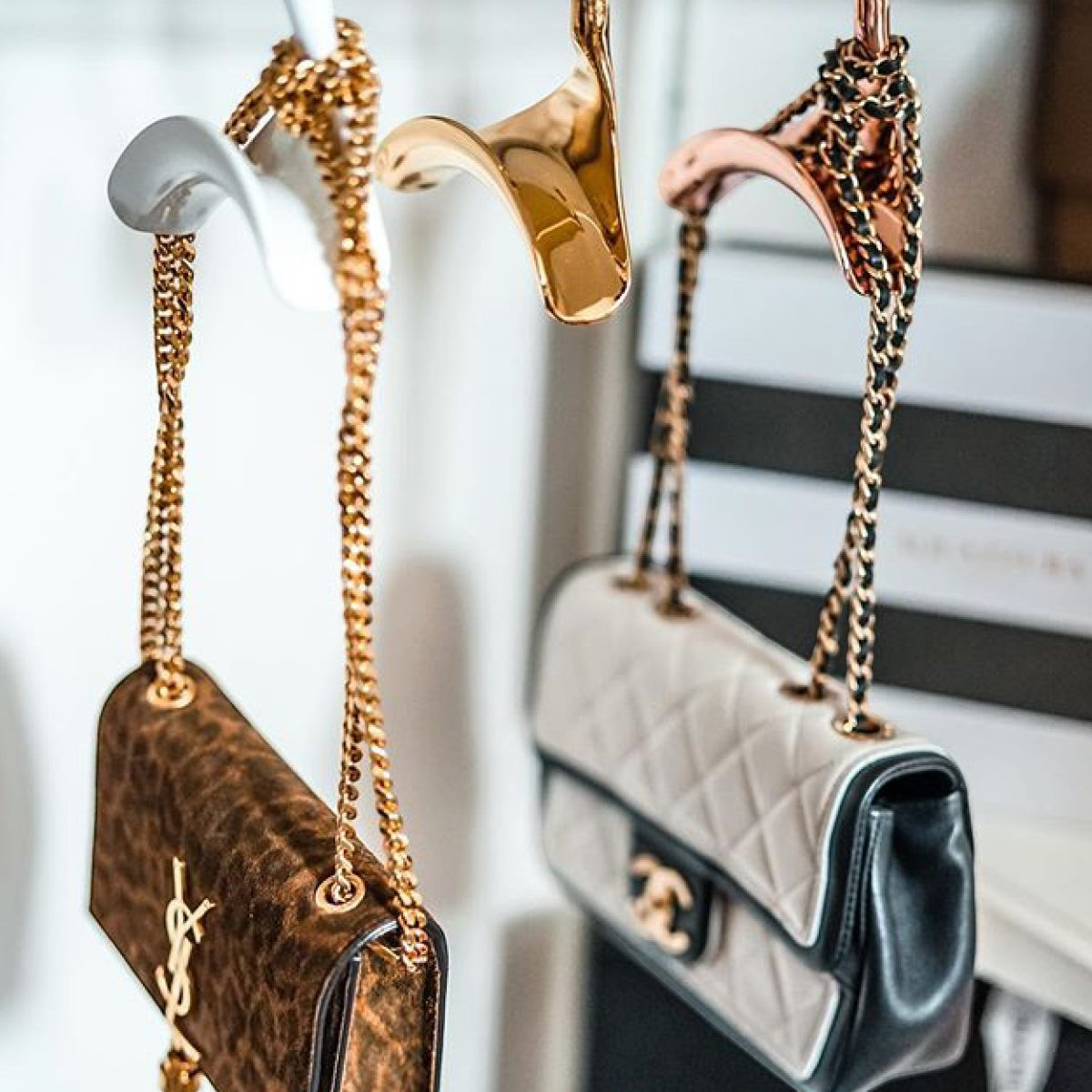 Bag-a-Vie gold metal handbag hangers holding luxury designer purses in a closet for organized storage