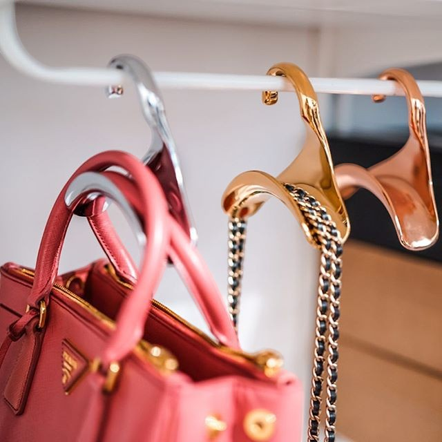 Bag-a-Vie gold and silver metal handbag hangers holding luxury purses on a closet rod