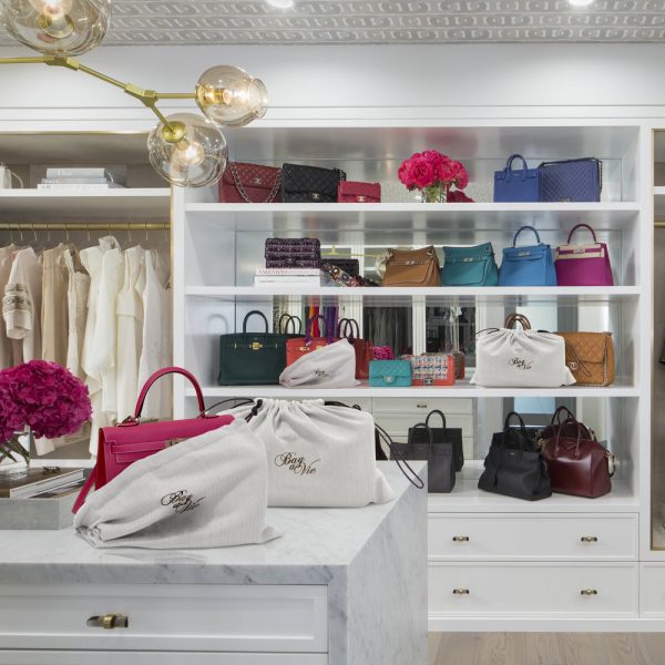 Bag-a-Vie natural herringbone canvas dustbags protecting luxury handbags on a marble closet island