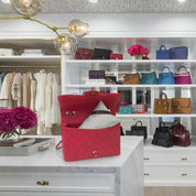 Bag-a-Vie classic petite handbag storage pillow shaper inside a red quilted designer bag in a luxury closet
