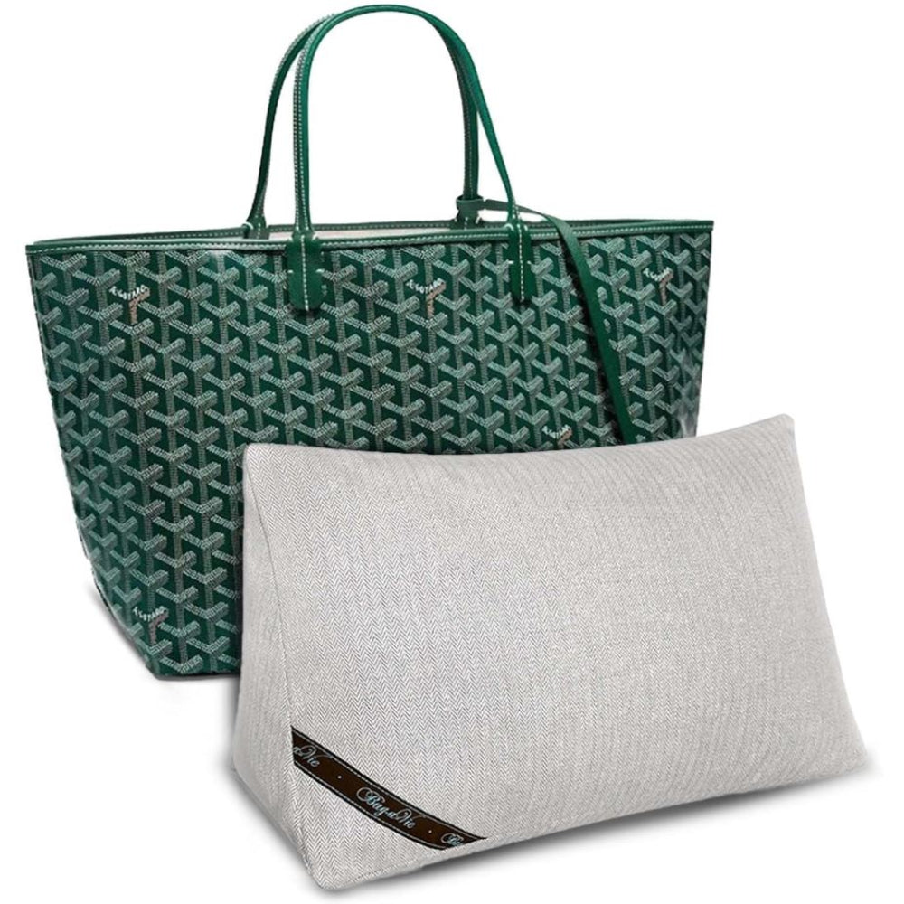 Bag-a-Vie purse shaper pillow in light grey herringbone fabric placed in front of a green patterned tote bag