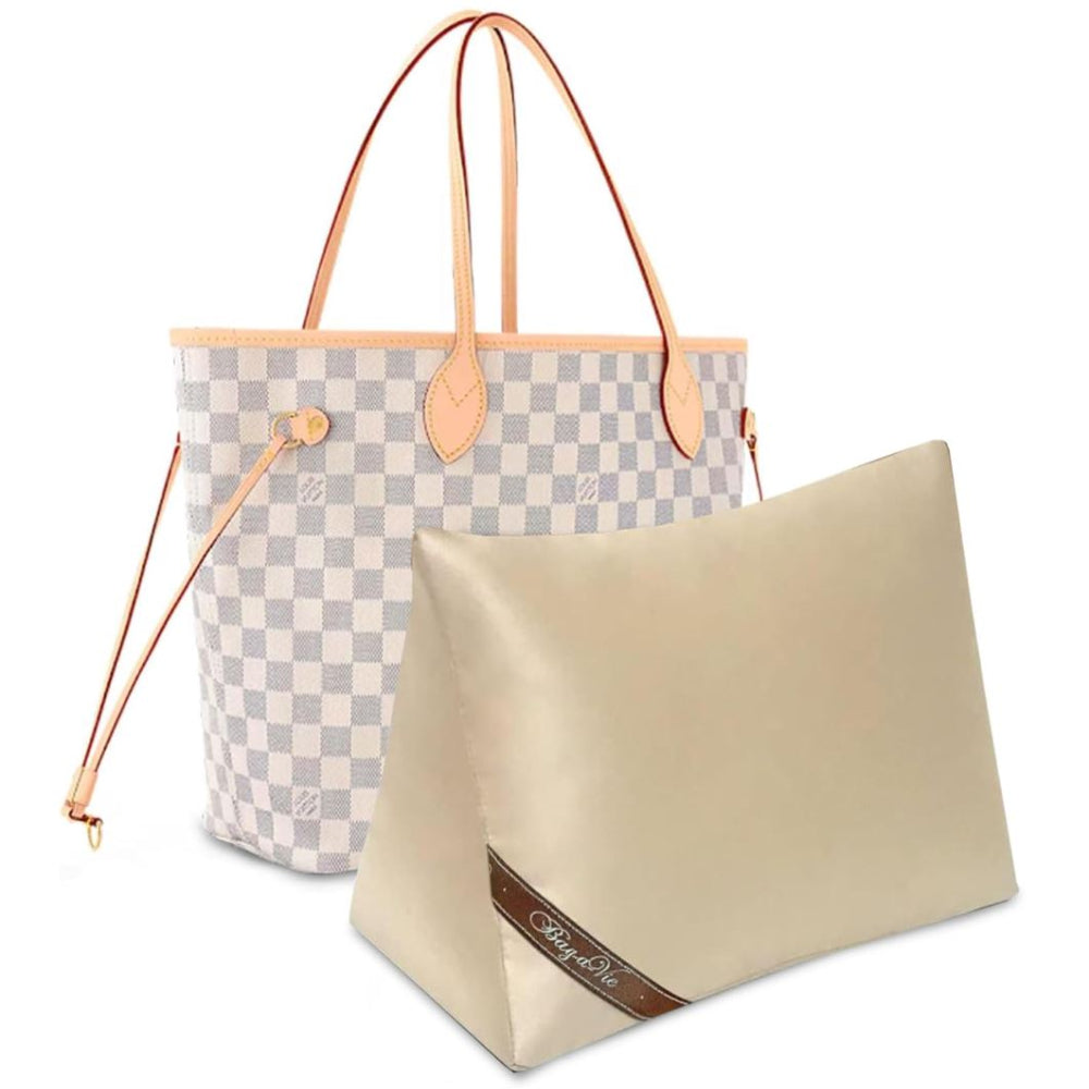 Bag-a-Vie purse shaper pillow in gold fabric placed in front of a checkered tote bag for shape preservation